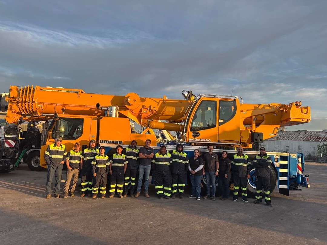Crane Monsters Corp. team standing in front of a Liebherr crane